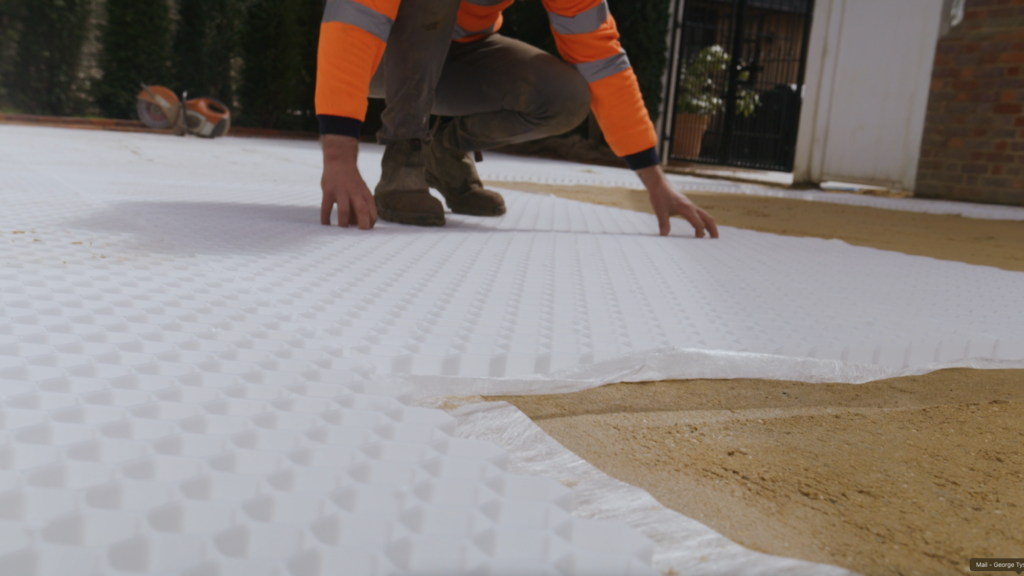 man laying down stable grids ready for landscaping