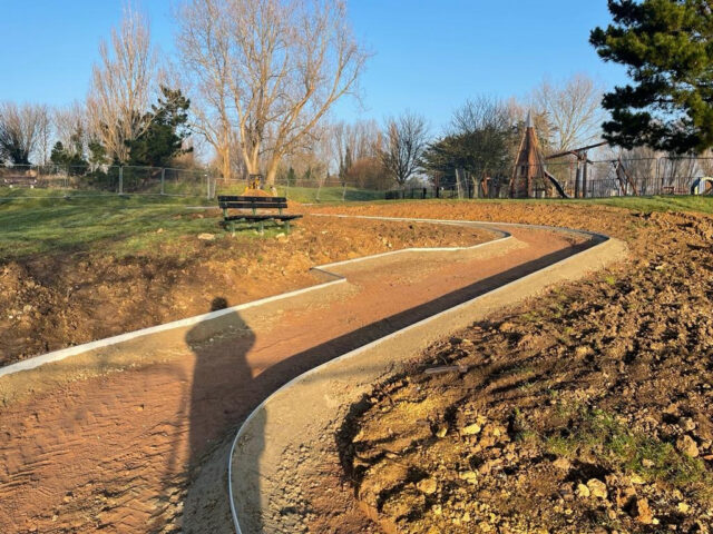 Aluminium edging defines a curving path during installation at Brooklands Park.