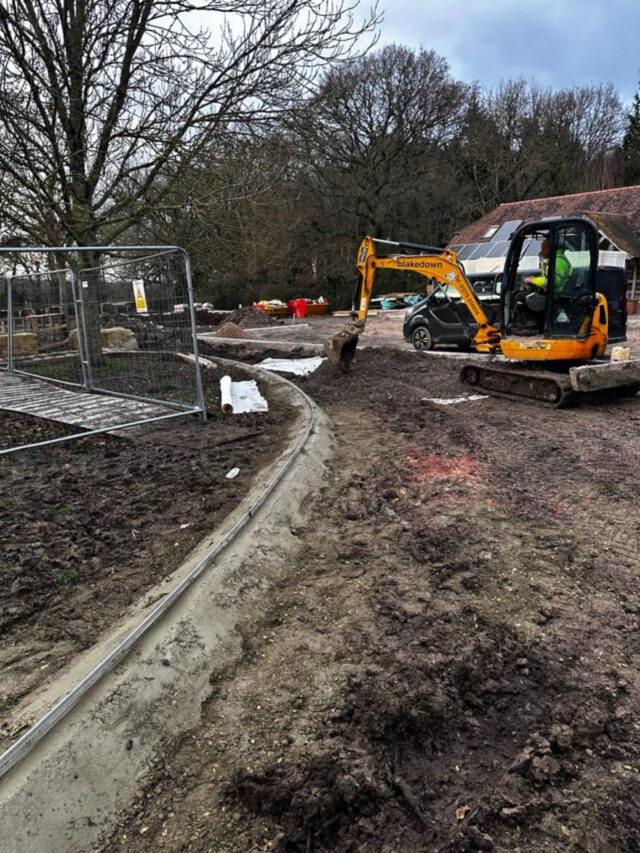 Curved edging and an excavator during installation at Itchen Valley Country Park.