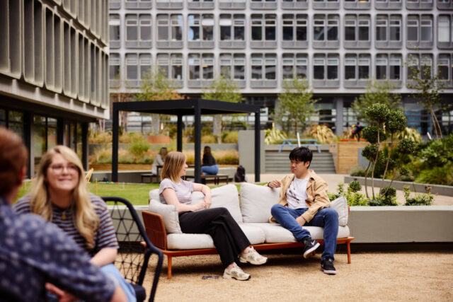 People using sheltered courtyard seating at Riverside.