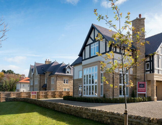 Stone and timber building facade with planting at Sussex Court.