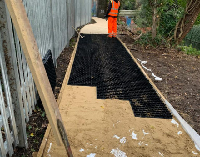 Path construction beside the railway boundary at Twickenham Gateway.