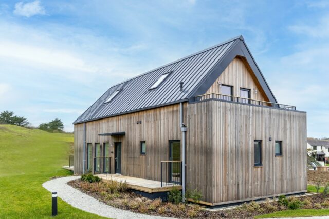 Timber-clad holiday home and gravel paths at Willingcott Valley.